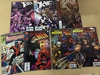 Photo of 7 X-Men related comic books spread out on a surface.