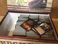 Opened box showing neatly stacked trading cards with visible Lord of the Rings logo on the backs and character cards on top.