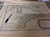 Vintage map showing Canada or Nouvelle France from 1756, with French text and decorative cartouche, visible moderate wear.