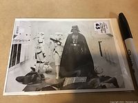 Clear image of the black and white 1977 Star Wars giveaway photo card showing Darth Vader and stormtroopers.