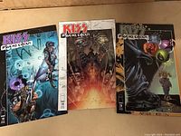 Photo showing three KISS Psycho Circus comic books #18, 19, and 20 with color detailed covers, arranged side-by-side.