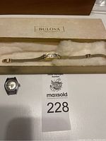 Watch in original Bulova box showing gold case and mesh band