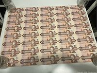 Full sheet of forty uncut Canadian two-dollar bills laid flat