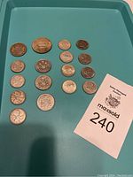 Full view of all 17 Canadian coins, silver and other metal, displayed on a tray.