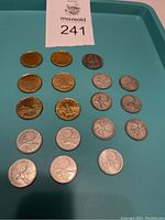 Overview of various Canadian coins separated into silver, Loonies and other coins