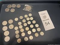 Full lot on black tray showing all coins and auction card