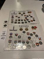 Two Canada provincial quarter sets displayed on presentation cards featuring Canadian province shields and a map, with maple leaf motifs. Each set contains multiple quarters from 1867-1992. Quarters are silver-colored and arranged on cards.