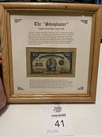 Front view of framed Canadian 1923 25 cent note known as the Shinplaster with detailed historical description text.