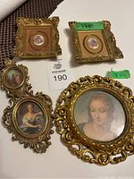 Four vintage gold framed art pieces displayed together, showing various frame shapes and artwork types including florals and portraits.