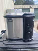 Front view showing Butterball branding and control panel with temperature dial and indicator lights.