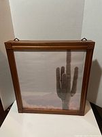 Front view of the large wooden jewelry box with picture frame door showing cactus image and carved wood corners.