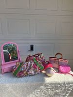 Full lot displayed on a flat surface featuring the vanity mirror and all handbags including the ball-shaped bag.