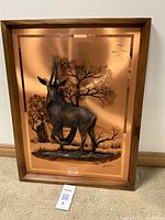 Full view of the framed 3D copper art plaque showing the antelope and natural scenery
