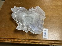 Top view of the milky white glass bowl showing wavy edges and layered pattern