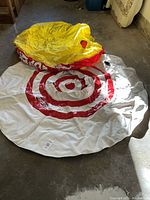 Top view of the deflated towable tube showing white top with red target design