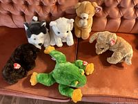 Set of six Ty Beanie Buddy and Classic plush animals displayed on couch showing all figures with Ty tags