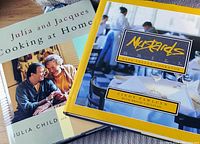 Photo showing both cookbooks stacked with visible covers: 'Julia and Jacques Cooking at Home' and 'Mustards Napa Valley Cookbook'