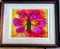 Frontal view of framed and matted colorful butterfly print signed by Sherwood in bottom right corner.
