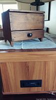 Front view of the primitive handmade wooden box showing the solid wood construction and drawer