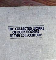 Close-up photo of the front hard-cover of the book showing the title printed in dark blue on beige cloth.