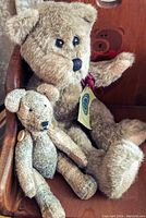 Full view showing large and small Boyds Bears seated in the wooden rocking chair, tag visible on the large bear.