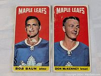 Front view of 1964-65 Topps tall boy hockey cards featuring Bob Baun and Don McKenney of the Maple Leafs showing wear and damage.