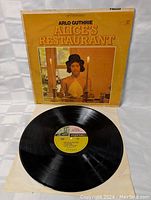 Vinyl record LP removed from sleeve showing yellow Reprise Records label in center and clean black vinyl disc with visible grooves.