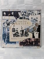Front cover of sealed Beatles 3 record set titled Savage Young at the Cavern Club featuring black and white collage images of the band.