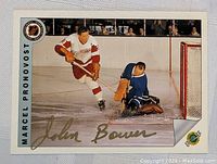 Full photo of vintage hockey card featuring action shot of Marcel Pronovost with Johnny Bower autograph