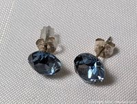 Front view of the sterling silver blue quartz stud earrings showing the oval faceted blue stones and silver settings.