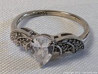 Close-up view of the sterling silver ring showing 925S hallmark inside band and crystal centerpiece with dragon wings design.