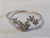 Close-up front angle showing the delicate floral cluster design on a sterling silver ring size 7.