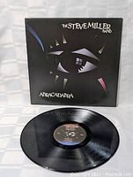 Photo showing Steve Miller Band Abracadabra album cover and vinyl record.
