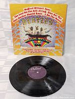 Front cover of the vinyl record sleeve featuring the colorful psychedelic artwork of Magical Mystery Tour by The Beatles.