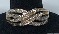 Front view of twist gold band ring with diamonds