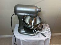 Silver KitchenAid Professional 550 Plus stand mixer with stainless steel bowl on table