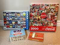 Lot showing VW Cool Faces unique VW van front images puzzle, Coca-Cola collage puzzle, and two boxed wine trivia games