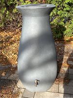 Front view of barrel on pavers with surrounding foliage