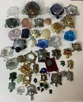 Top view of entire turtle collection showing assortment of glass, metal, and stone figurines in multiple colors and sizes