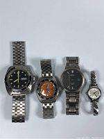 Four watches displayed in a row on white background