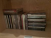 Shelved music CDs showing various artists including Tony Bennett and others, stacked side by side.