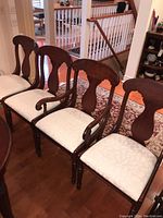Set of four Lexington dining chairs, showing two chairs with armrests and two armless chairs, polished wood and light upholstery.