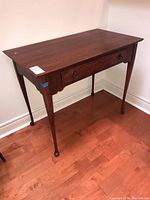 Full side view of the Lexington wood desk showing the top, drawer, legs and overall condition.