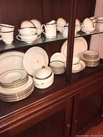 Wide view of cabinet showing teacups, saucers, salad plates and dinner plates