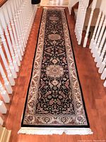 Full-length view of runner on hardwood floor showing overall pattern and fringe