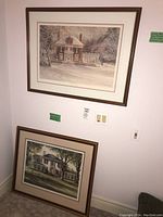 Wall-mounted framed print of a snow-covered house titled "Winter Retreat" with visible signature and edition number.