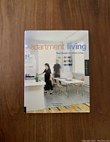 Front cover of the book showing title and authors, a kitchen and dining area photo with two people.