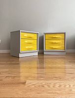 Front view of both nightstands side by side on hardwood floor against wall