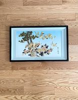 Full view of framed vintage Asian shell wall art depicting birds and flowers on tree branches.
