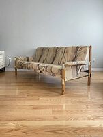 Full front view of sofa showing three-seat cushion and fabric pattern